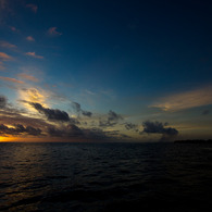 黒い海と小さな夕日