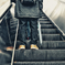 A father and a son on the escalator.