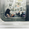 A woman beyond the train window.