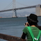 a girl taking a picture of SF bay