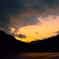 夕陽が舞い降り山を縁取る