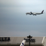 雲と成田空港の風景・ホヌの尾翼とQATAR A350