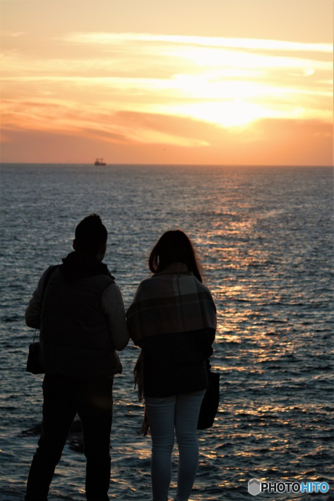 夕日の海岸と二人