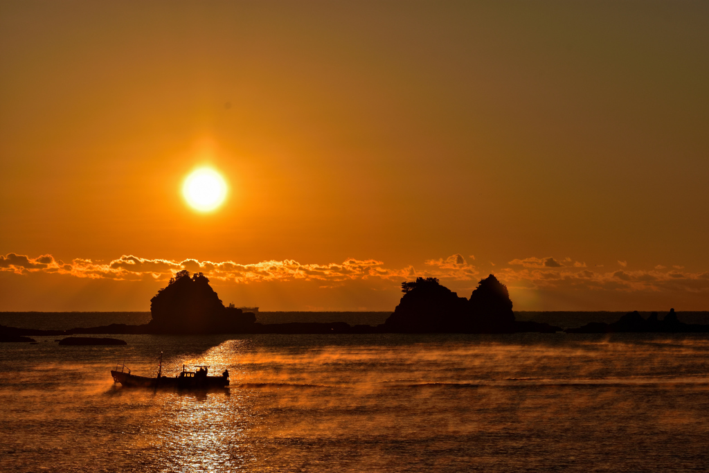 A sunrise with a ship