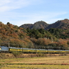 紅葉の山々を背に