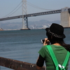 a girl taking a picture of SF bay