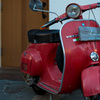 With a red Vespa