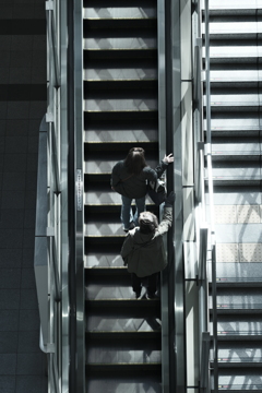 two people on an escalator