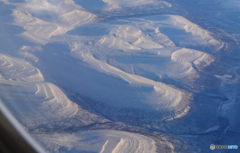 「飛行機」丸窓から見る・ロシア 雪山