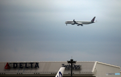 雲と成田空港の風景・ホヌの尾翼とQATAR A350