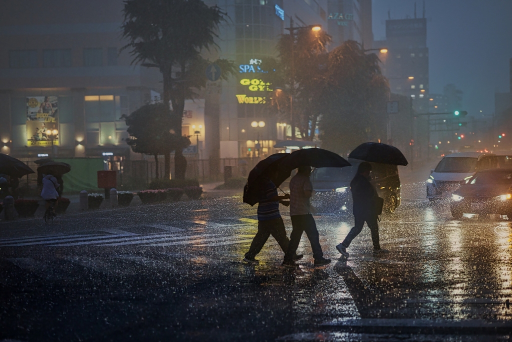 雨の中の三人