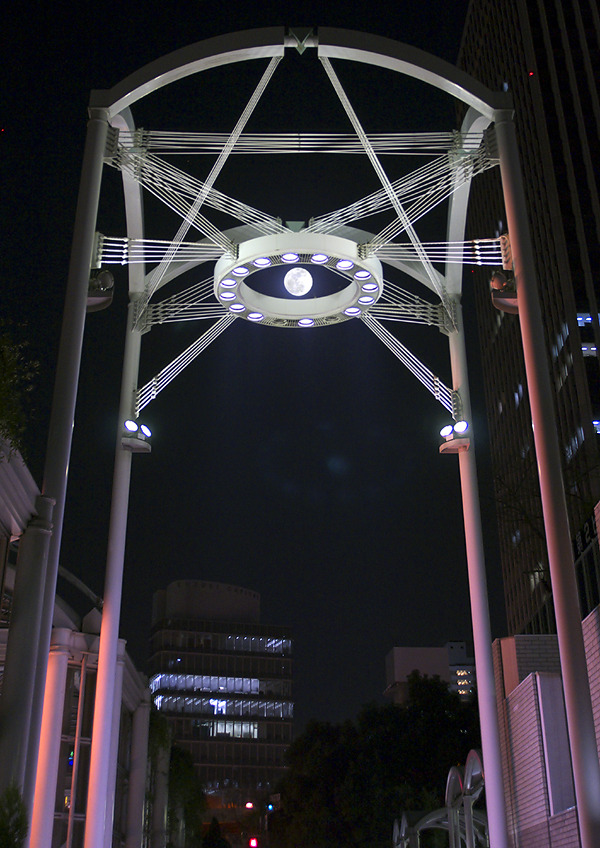 The full moon rises on Umeda.