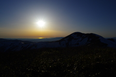 羽後朝日岳の稜線から男鹿半島に落ちる夕日を眺める