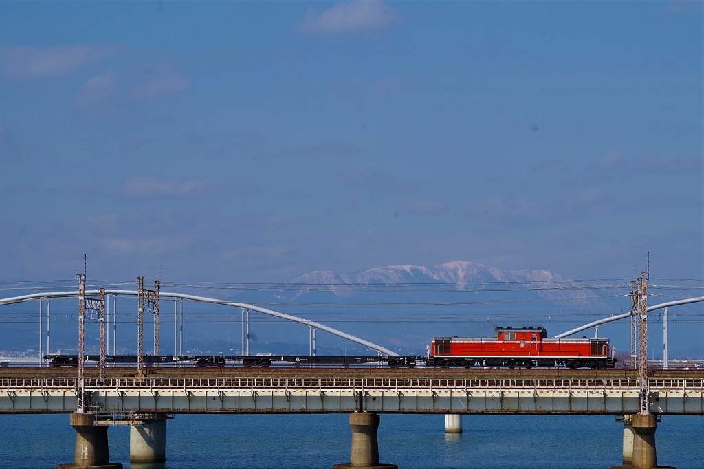 比良山に積もる雪と走る訓練列車