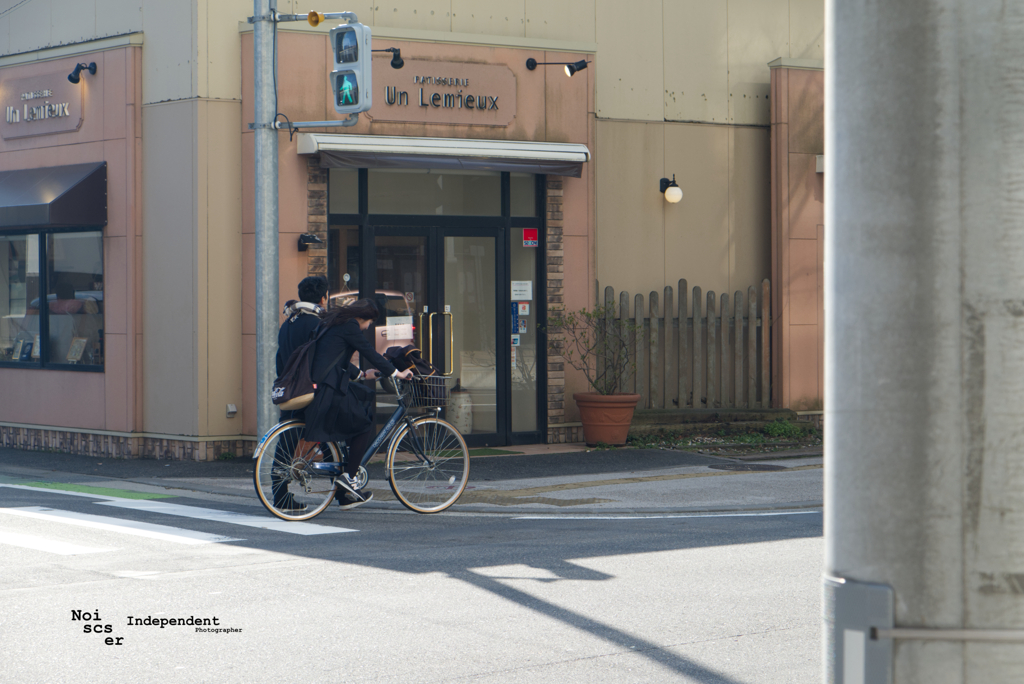 Couple on bike and one man walk 