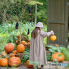 Little girl playing with a pumpkin ...