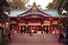 夕暮れの神社とカップル
