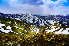 春の山、いまだ雪を残し