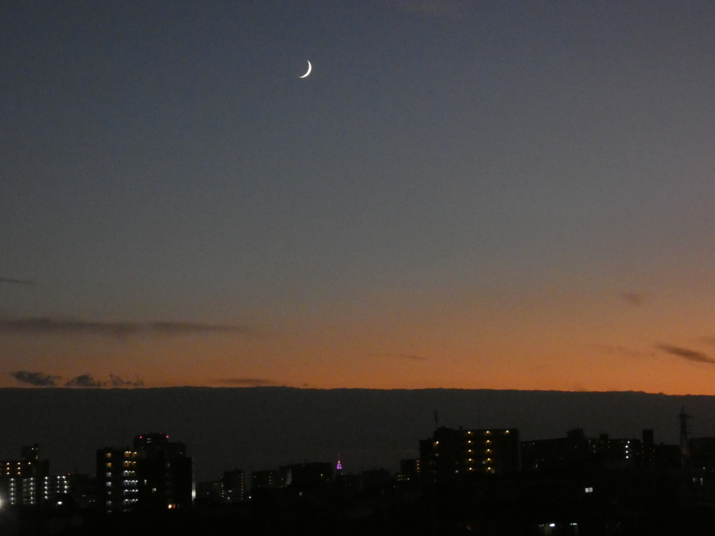 黒雲のカーテン上の三日月