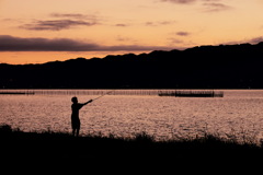 琵琶湖で釣りをする少年