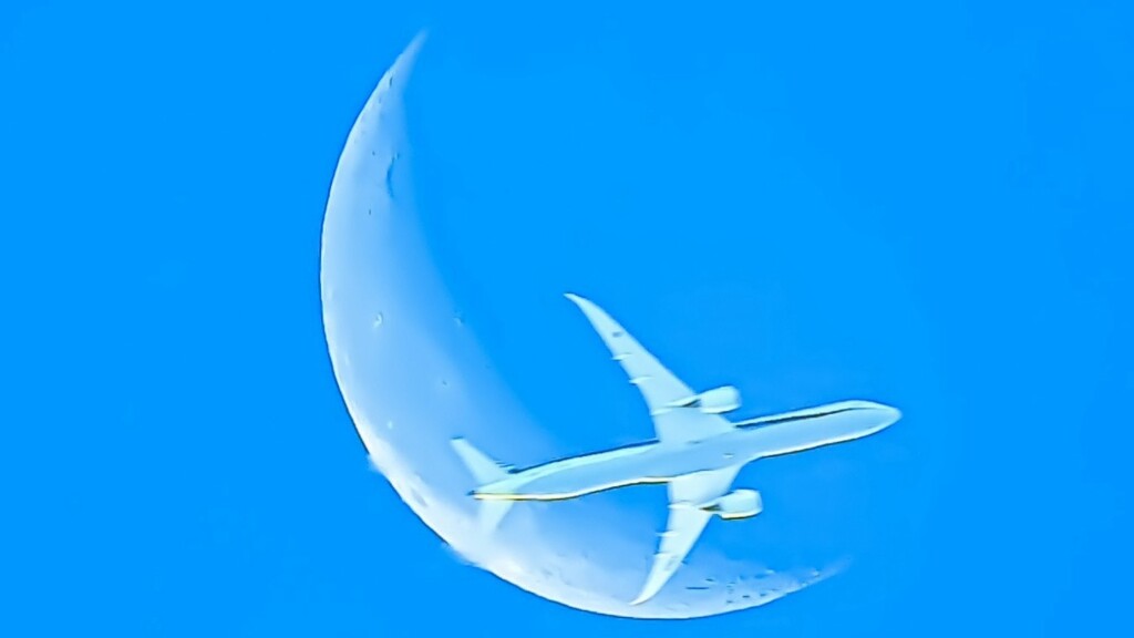 朝の月と旅客機。
