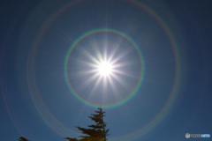 輝く太陽と虹の輪