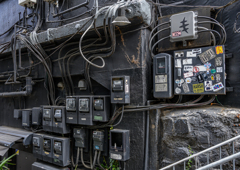 Meters and cables on a black wall