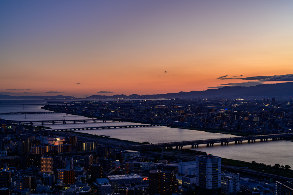 Bridge and the city at sunset