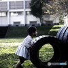 タイヤを押す少女