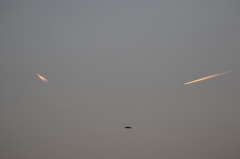 夕日に輝く飛行機雲