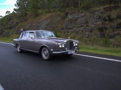 an old Rolls-Royce with Australian flags
