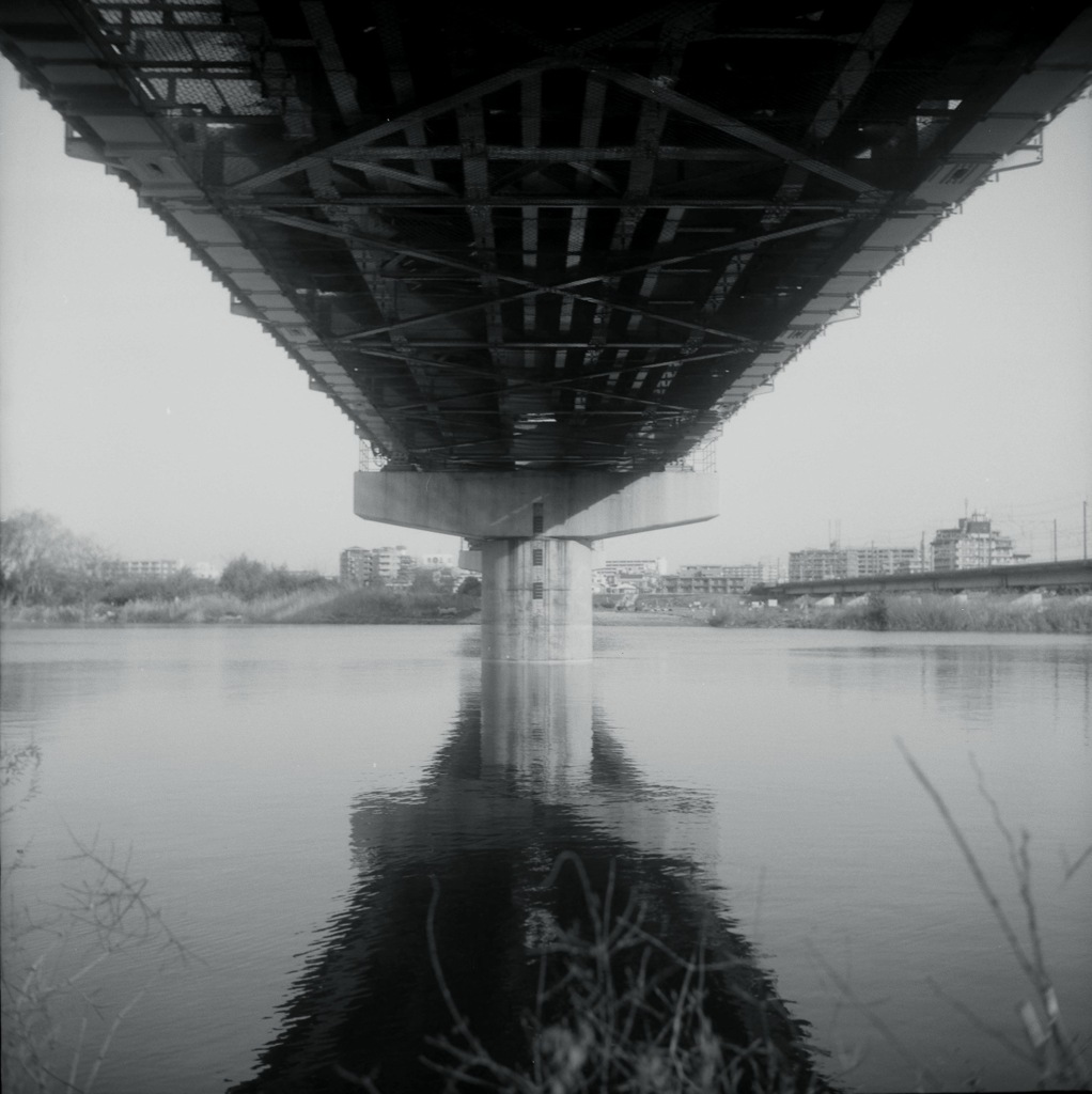 Under the railway bridge.