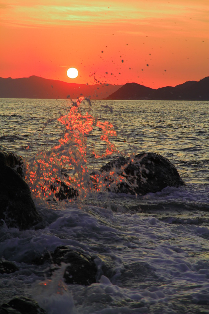 海と夕日と波