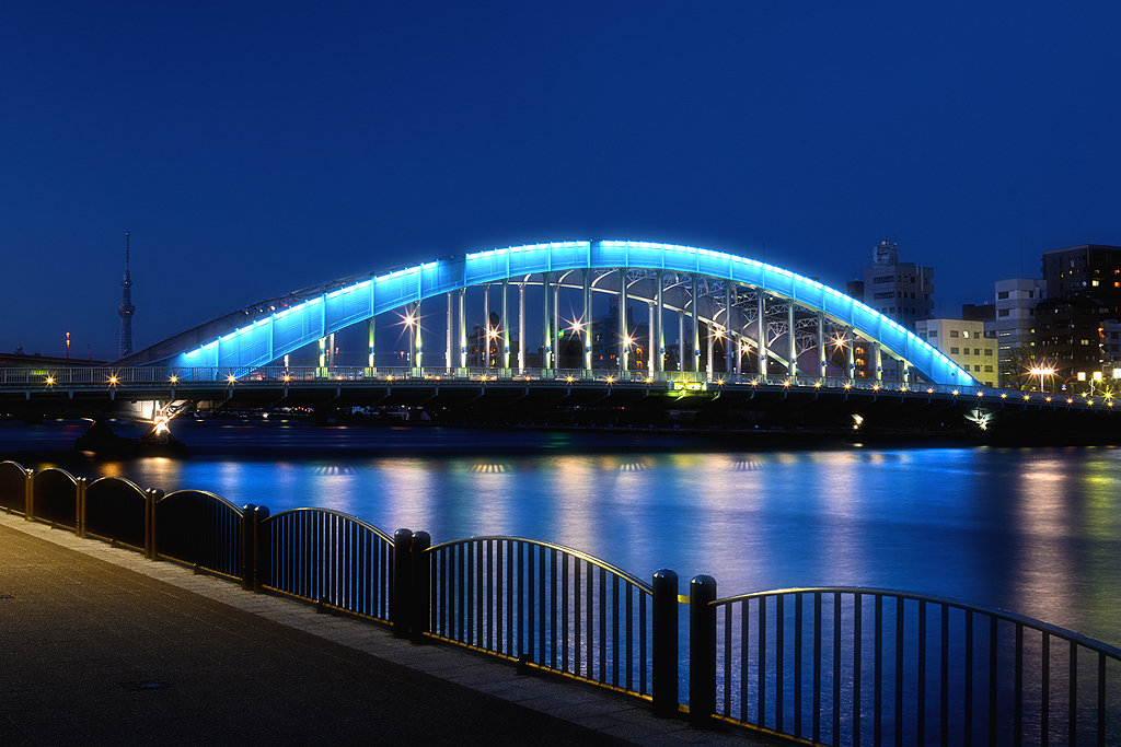 青く輝く永代橋とスカイツリー