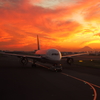 Towing airplane under the red sky