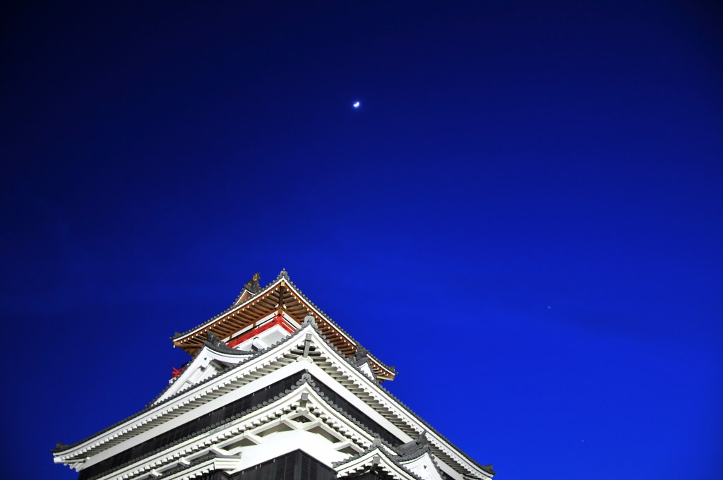 夕暮れの城に月