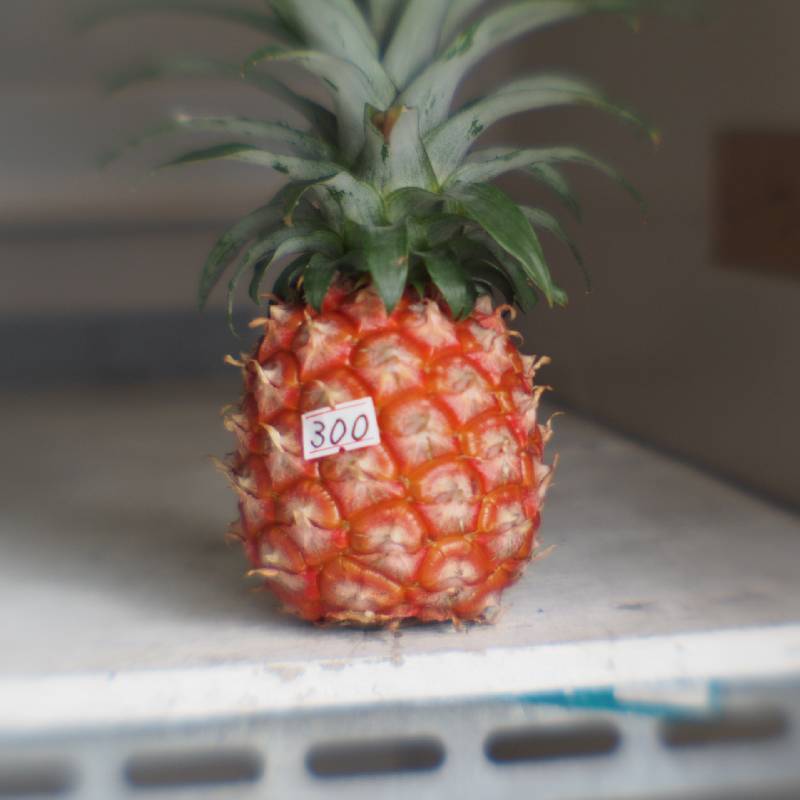 Pineapple on vending-shelf