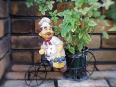 Small doll in front of a restaurant