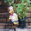 Small doll in front of a restaurant