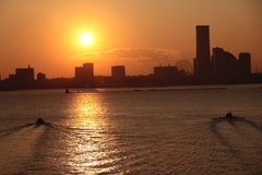 Two boats heading for the sunset