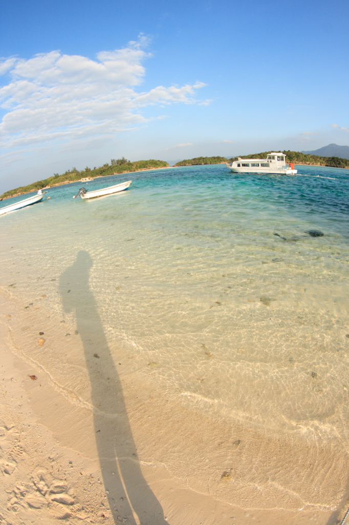 A cameraman on the beach.