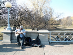 a grandpa with a guitar at the park