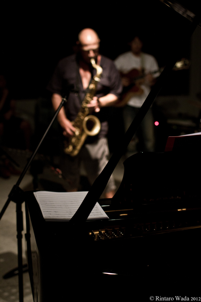 Behind the piano stands a giant