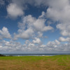 オホーツク海と牧草地と雲