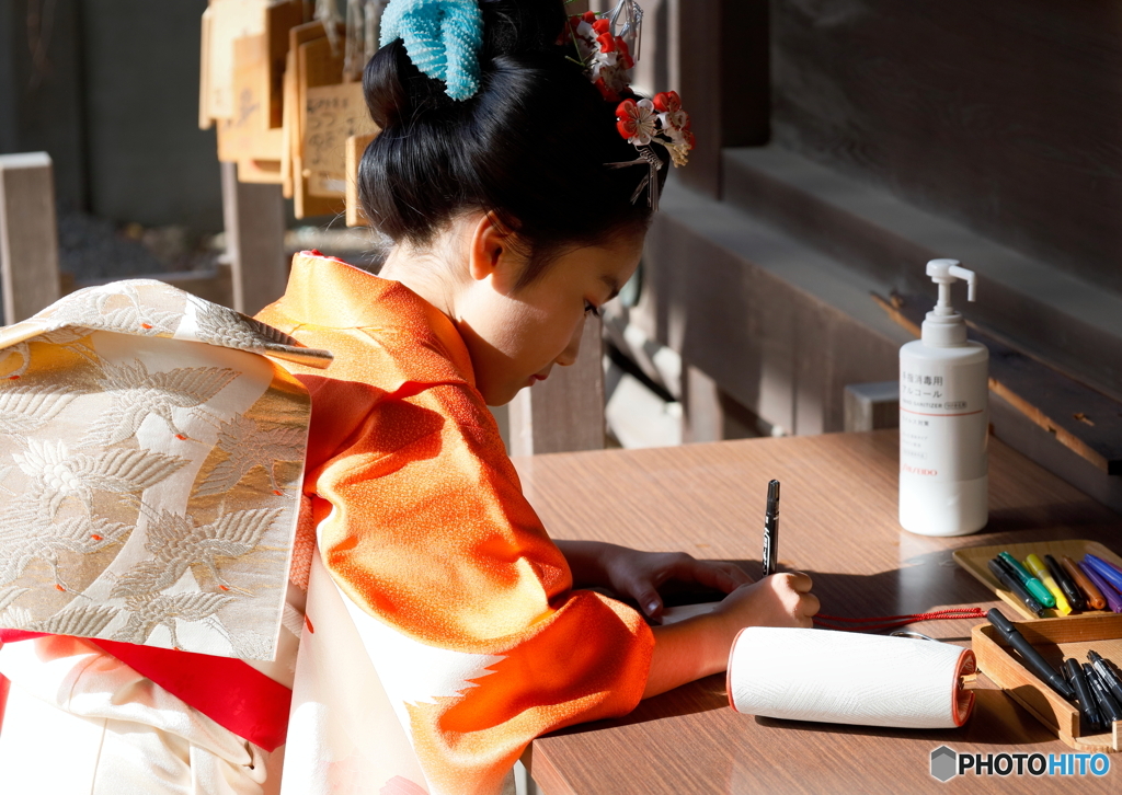 七五三の日に・絵馬を書く少女