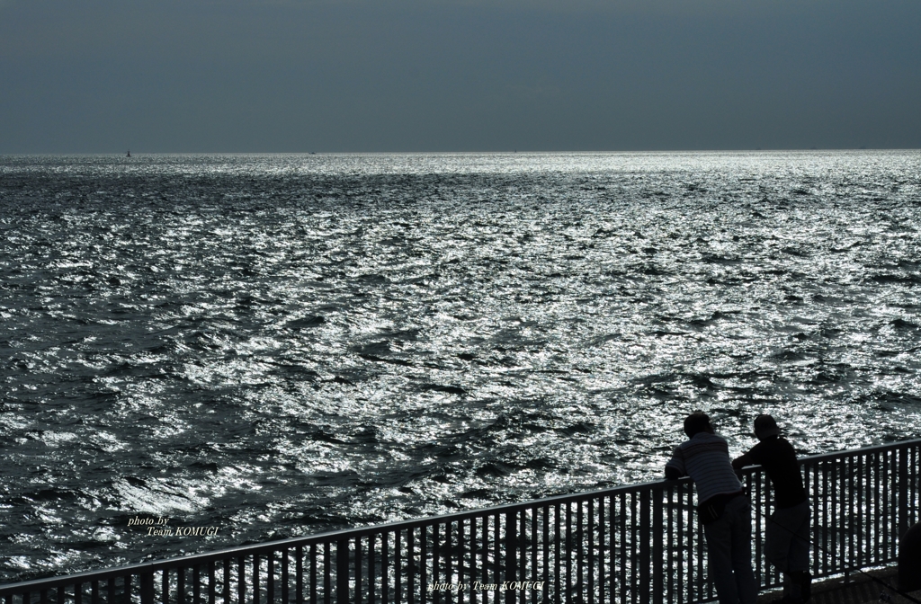 In front of the sea.