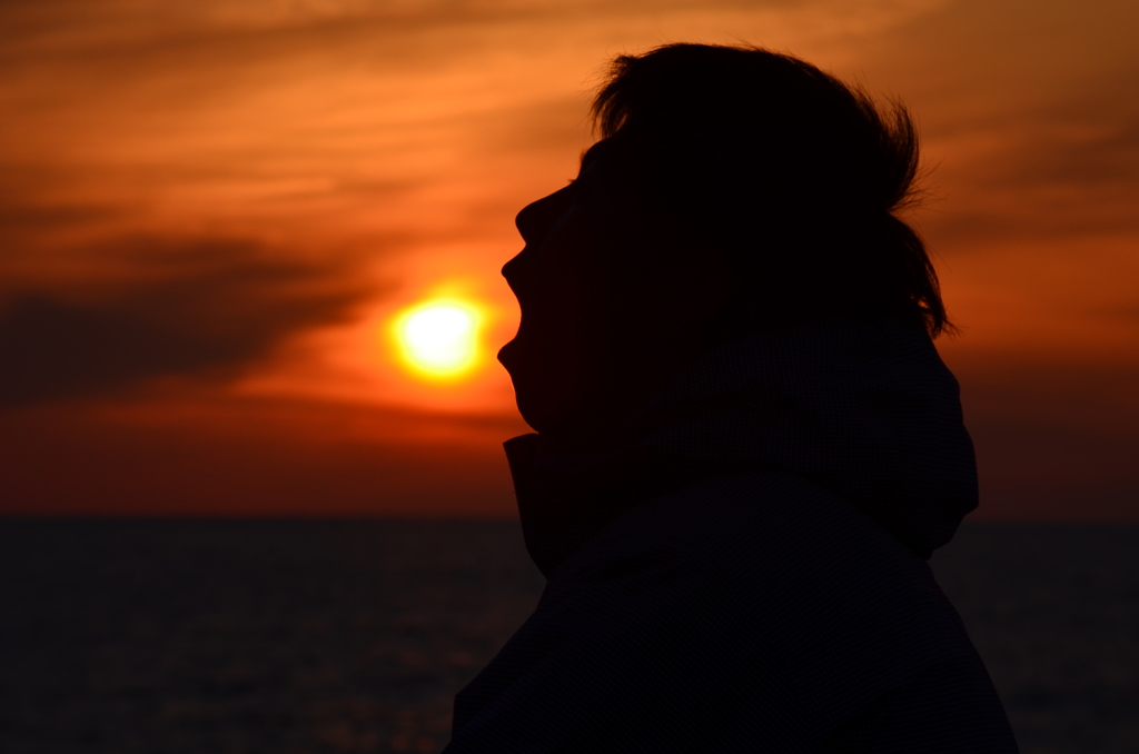 夕日と人