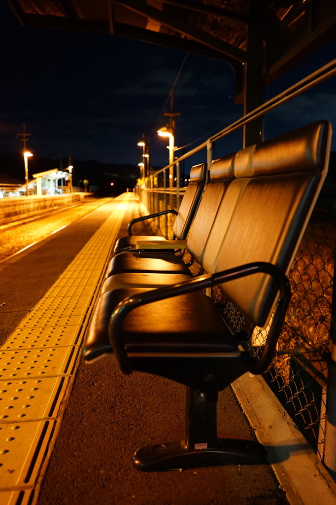 夜のホームにたたずむ