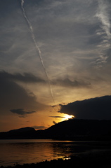 飛行機雲と夕日
