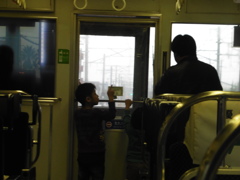 列車内で前面展望を眺める親子連れ